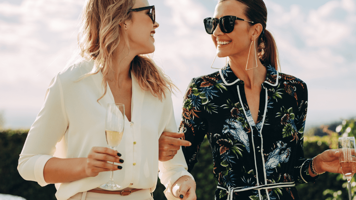 Fashionable Female Friends with Wine Outdoors